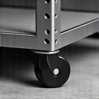 Heavy-duty caster wheels attached to the base of a shelving unit, on a concrete floor
